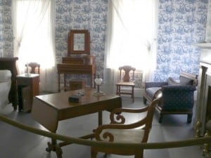 room filled with furniture and wallpaper on the walls