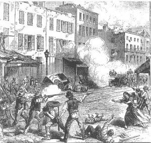 An engraving showing men firing down a city street at soldiers with cannons. Several dead and wounded are on the ground and a woman rushes toward one of them.