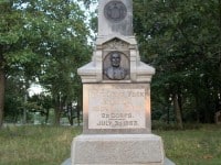 Granite monument with the NY seal above a a carving of a man's head and shoulders above the words 126th New York Infantry, 3d Brig, 3d Div, 20 Corps. July 3d, 1863.