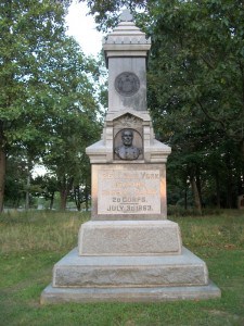 Granite monument with the NY seal above a a carving of a man's head and shoulders above the words 126th New York Infantry, 3d Brig, 3d Div, 20 Corps. July 3d, 1863.