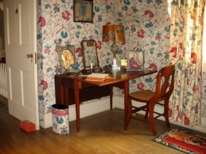 Antique writing table in a corner.