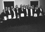 A group of men in tuxedos and masonic aprons posing for the camera.