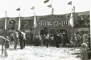 People standing at the entrance to the James M. Cole Big Circus Sideshow.