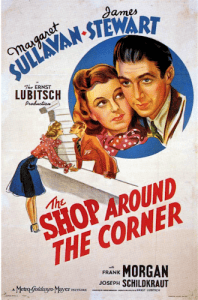 A poster for The Shop Around the Corner with illustrations of a man and woman bending toward one another for a kiss and a close-up inset circle illustration of Margaret Sullavan and James Stewart.