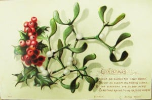A Christmas postcard with a sprig of holly.