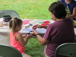 Woman and child doing a craft.