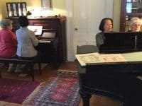four-women-playing-two-pianos