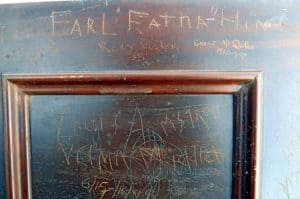 Section from a front piece of an upright piano with signatures from musicians who played at Club 86 in the 1940s and 1950s.. Signatures of Earl "Fatha" Hines, Louis Armstrong, and Velma Middleton.
