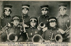 Black and white photo of a six men holding musical instruments