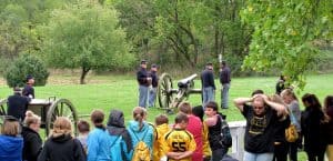 civil war re-enactors firing a cannon