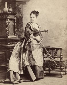 Sephia of a photo of woman posed with a violin