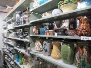 view-of-shelves-filled-with-pitchers-and-china-in-storage