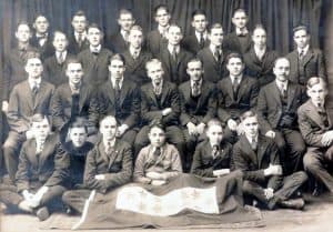 group of men and young men sitting and standing