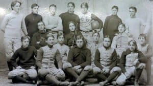 A group of young men sitting and standing