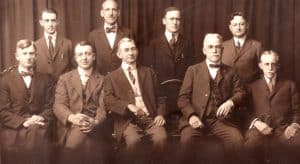 group of gentlemen sitting and standing