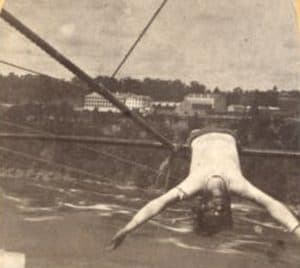 Man laying across a tightrope