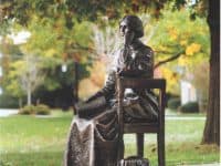 statue of women sitting in a chair