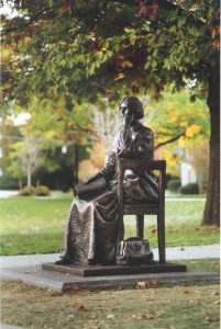 statue of a woman sitting in a chair