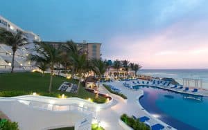 hotel and pool along side a beach