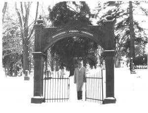 man standing under an arch in the snow