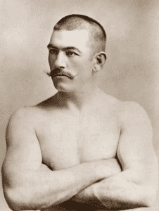shirtless man with a moustache