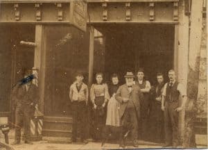 men and women standing outside an office