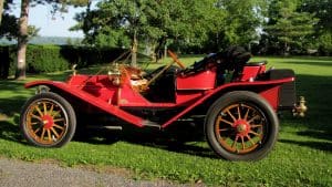 red, brass car in a lawn