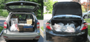 two vehicles with trunks filled with boxes and bags