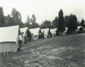 children-standing-outside-tents