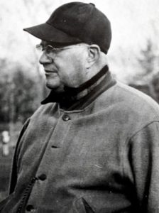 older man in a baseball cap and jacket