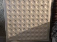 square shaped radiator on a stand with rows of circles