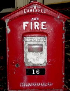 Red metal box that served as a fire alarm pull box.