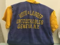Blue and yellow t-shirt with back label Hook and Ladder Untouchables, Geneva, NY.