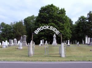 the gate into Brookside Cemetery from the opposite side of the road