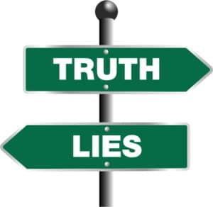 Two arrow street signs pointing in opposite directions labeled truth and lies.