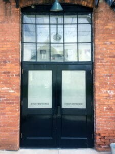 Brick Building Black Doors Event Entrance