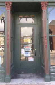 Decorative Entrance with Green Door and Warning Signs