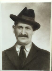 Man In Hat Dark Coat With Mustache