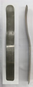 Front and side view of a strip of metal with a curve in it.