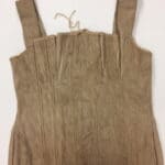 Flat front view of a beige corset with two shoulder straps/