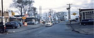 View of Lake Street to Lake with a diner, Firestone, and Texaco on the left and a Sunoco on the right.