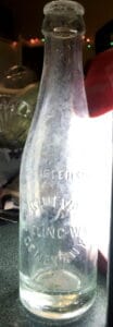Tall, clear glass bottle