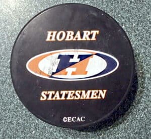 Black hockey puck with "Hobart," "Statesmen" and a large "H" printed on it