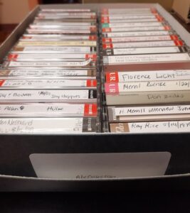 two rows of cassette tapes in a box