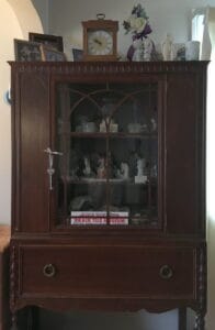 knicCChina cabinet filled with knacks and memorabilia
