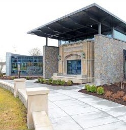 Sidewalk To Stone And Glass Building