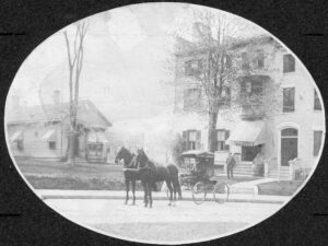 orse and buggy in front of a single story building and a multi-story building