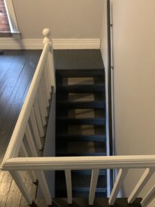 Portion of a room at the top of a staircase in the Housman home