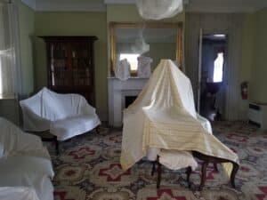 furniture in the Back Parlor of Rose Hill Mansion covered with sheets