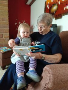 elderly woman reading to a child